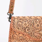 Brown leather wallet with intricate floral patterns on a white background