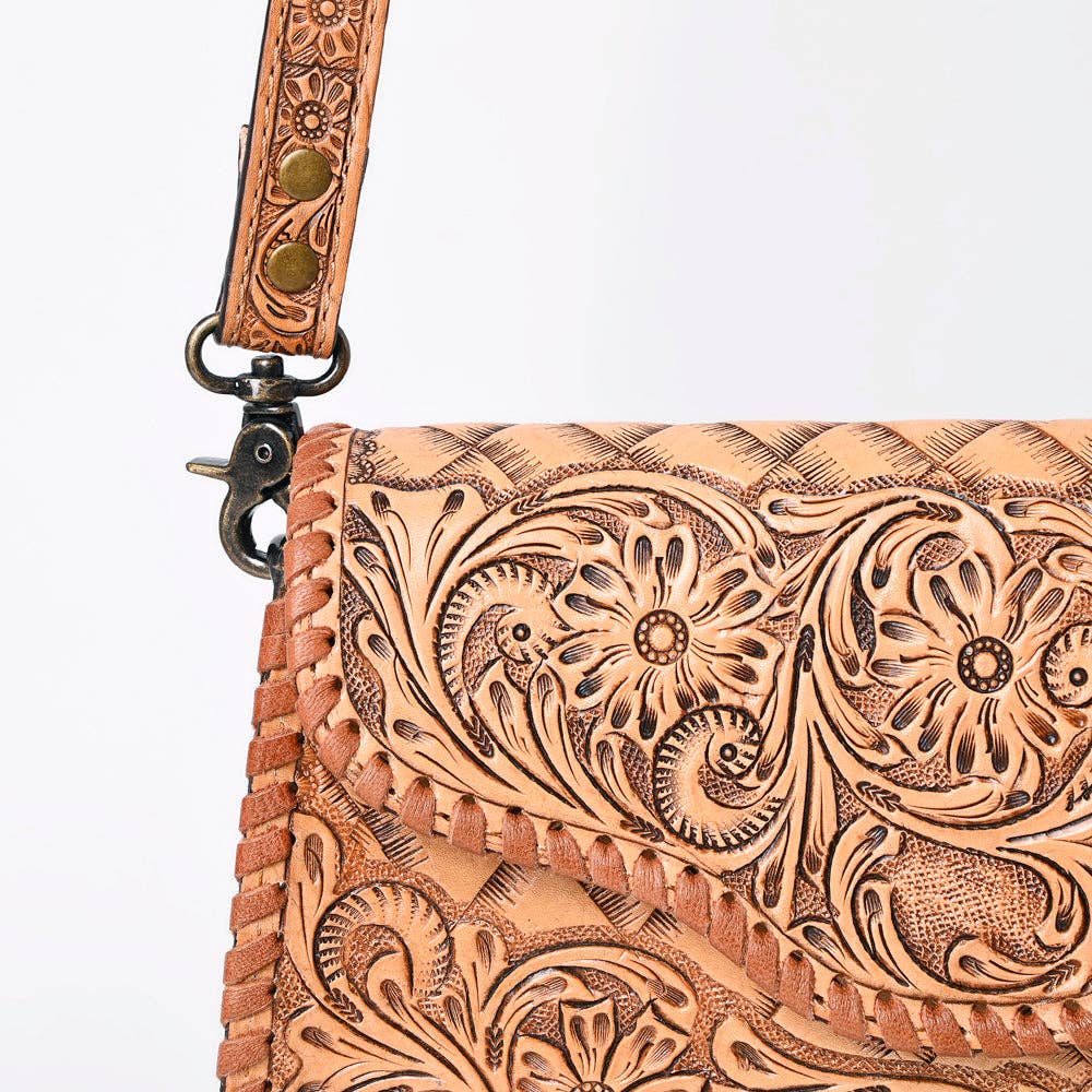 Brown leather wallet with intricate floral patterns on a white background