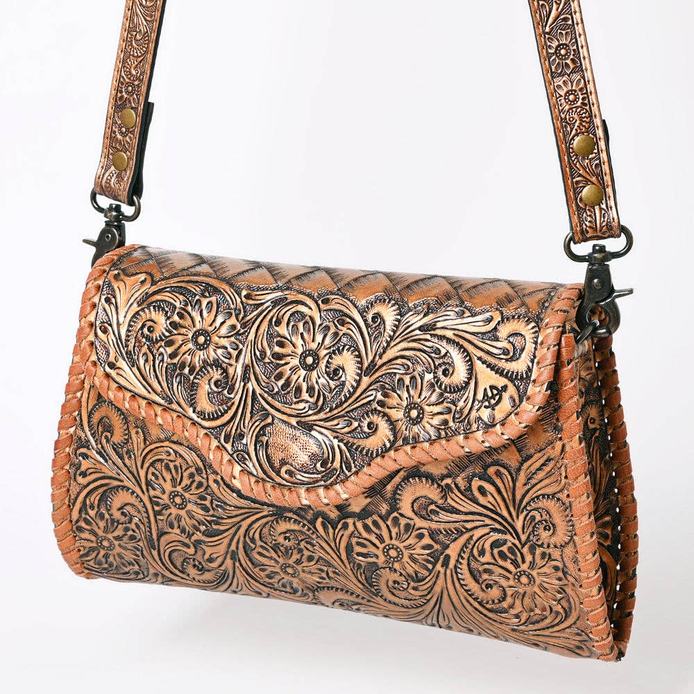 Metallic brown leather handbag with intricate floral patterns on a white background