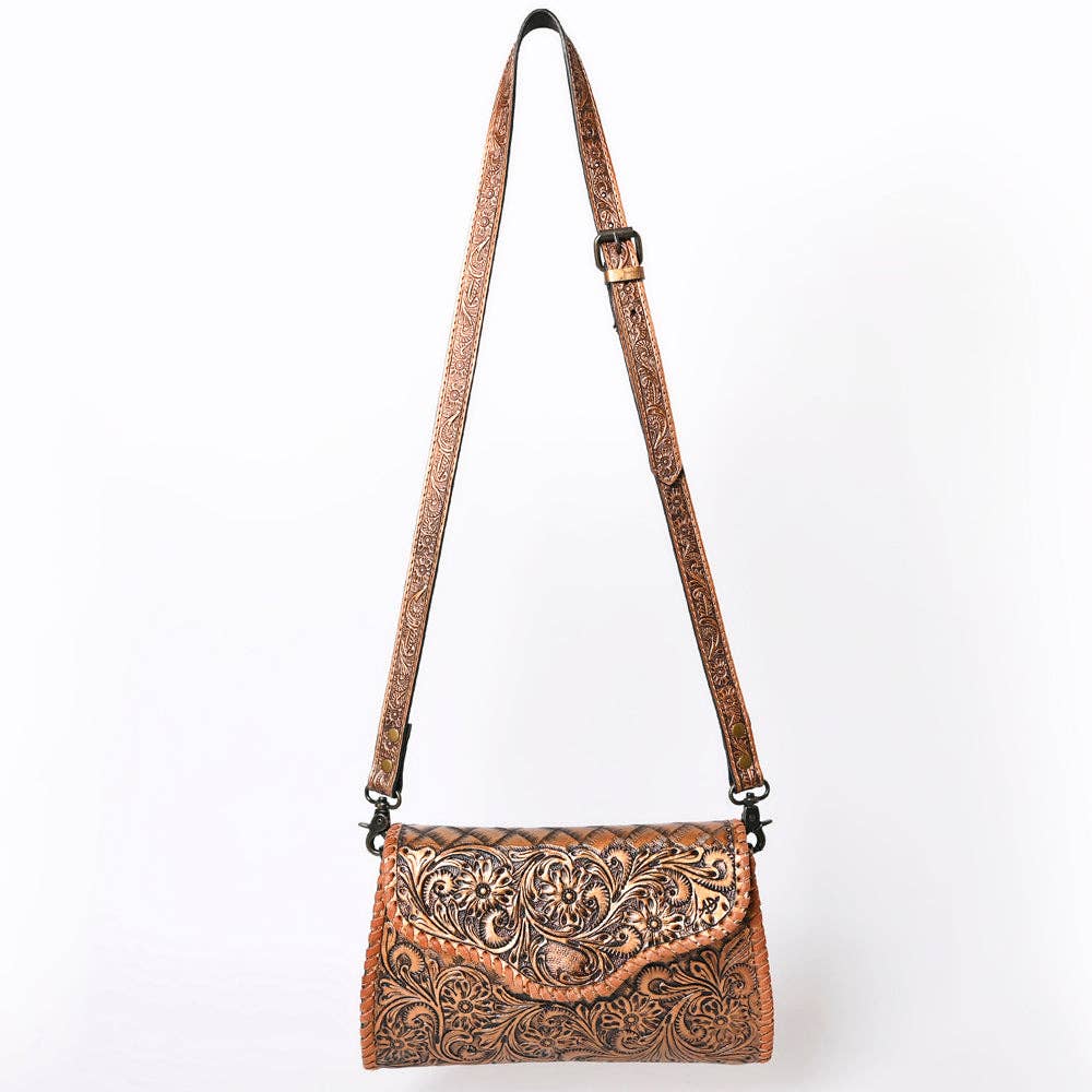 Brown leather handbag with intricate patterns on a white background