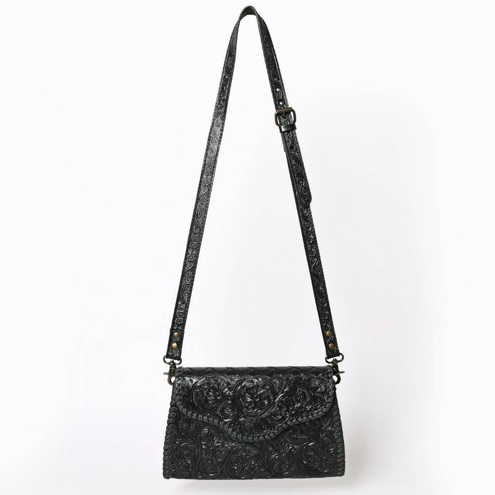 Black embroidered handbag with a strap on a white background