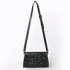 Black embroidered handbag with a strap on a white background