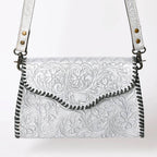 Metallic Silver leather handbag with intricate black tooled patterns on a white background