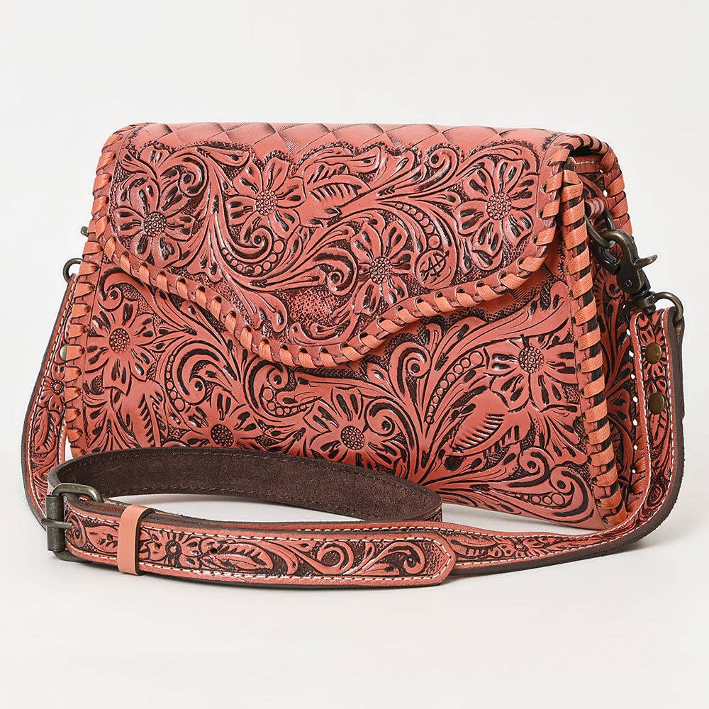 Coral leather bag with intricate patterns on a white background