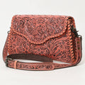Coral leather bag with intricate patterns on a white background
