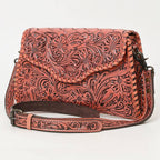 Coral leather bag with intricate patterns on a white background