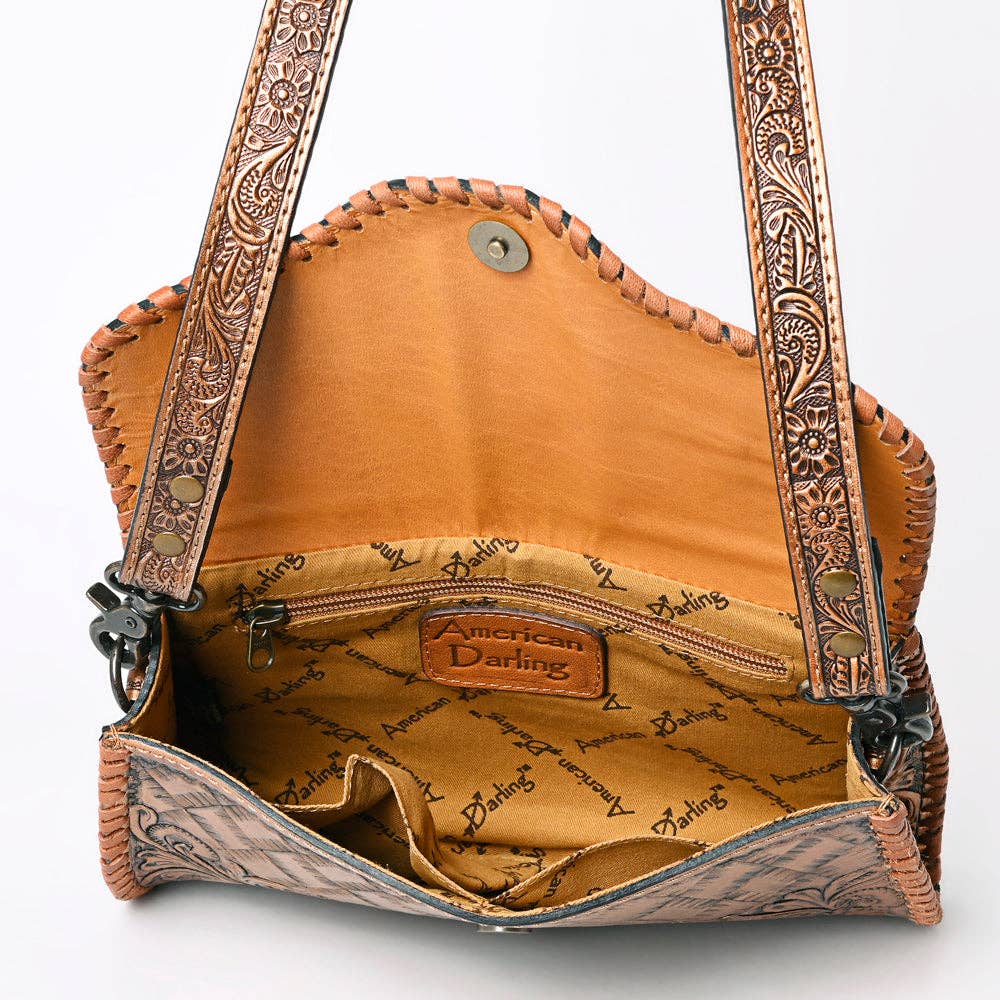 Brown leather handbag with intricate patterns and 'American Darling' branding on a white background