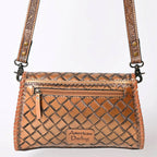 Brown woven handbag with decorative strap on a white background