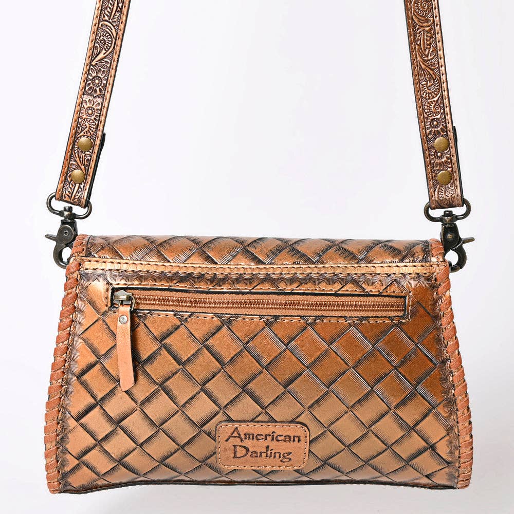 Brown woven handbag with decorative strap on a white background