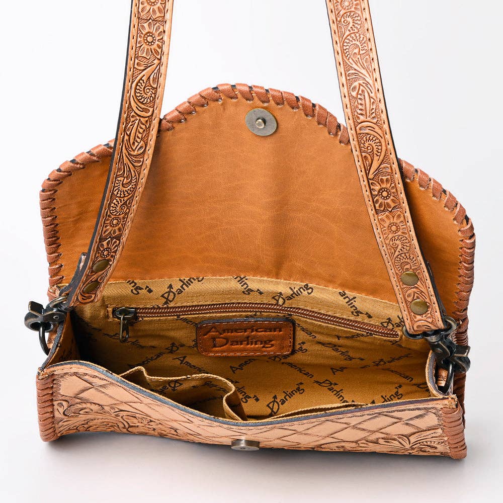 Brown leather handbag with intricate patterns on a white background